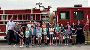 Girl Scouts around a fire truck during fire school