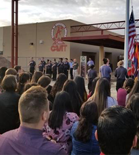 Students and staff give the Pledge of Allegiance in front of CAVIT